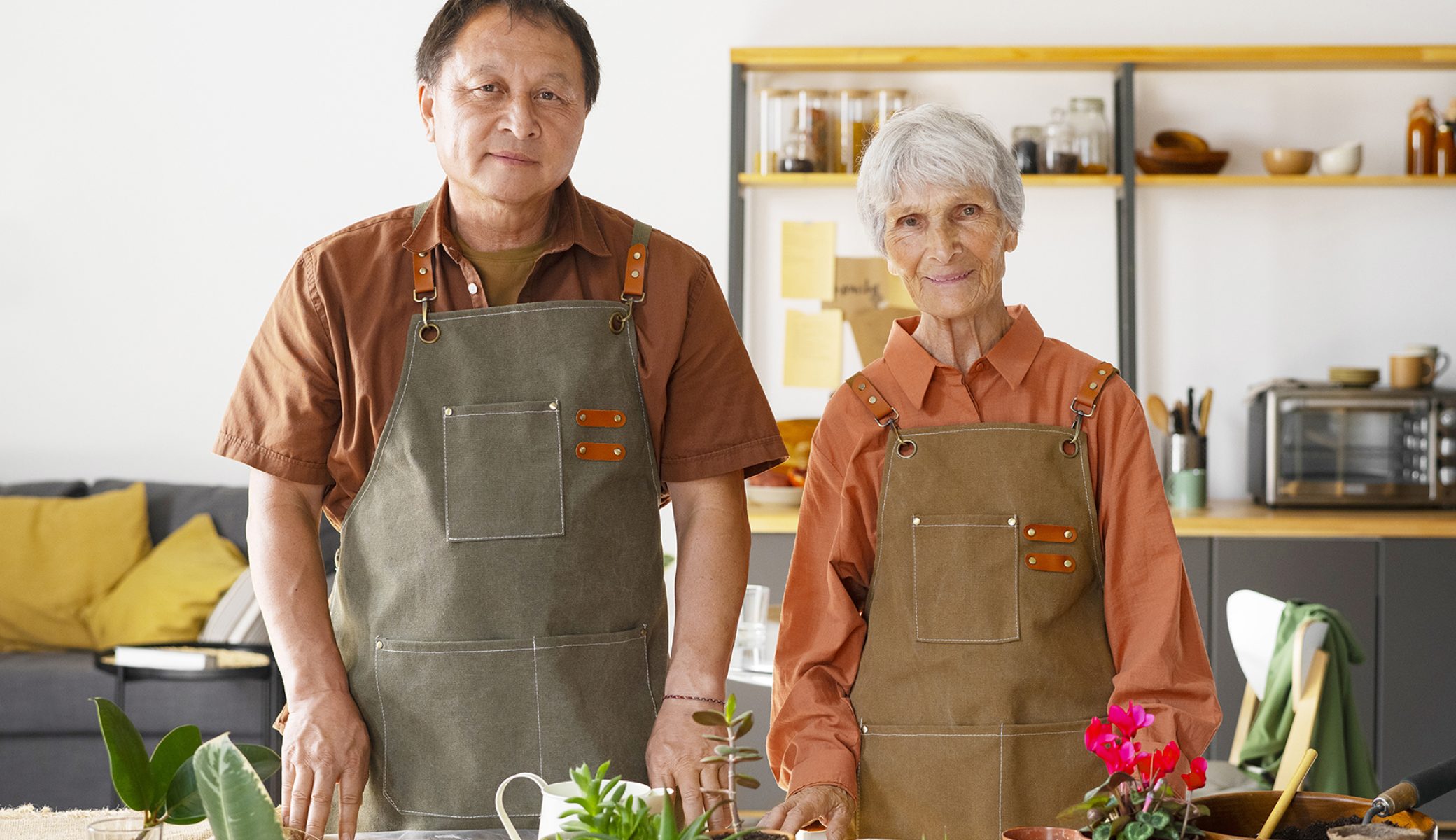 portrait-senior-couple-repotting-plants-home